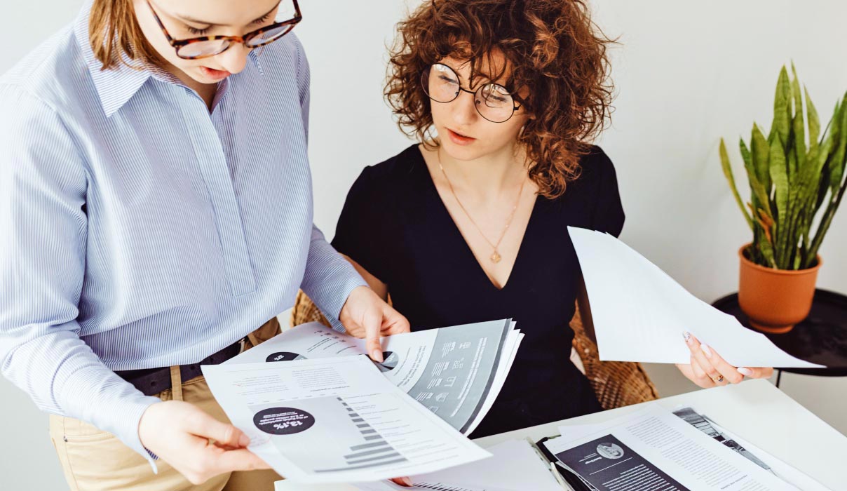 Two Women Reviewing Documentation complex residency filings